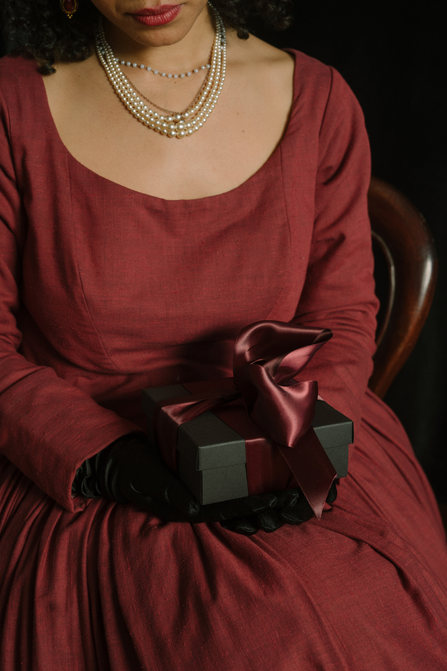 Woman in Victorian Dress with Christmas Gift